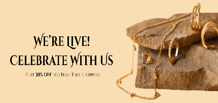 Gold jewelry on a stone surface with promotional text on a beige background